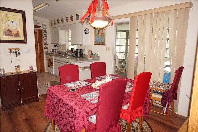 dining space featuring dark hardwood / wood-style flooring and sink