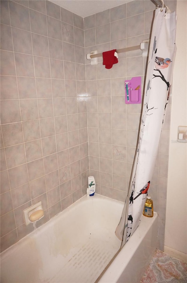 bathroom with shower / bath combination with curtain