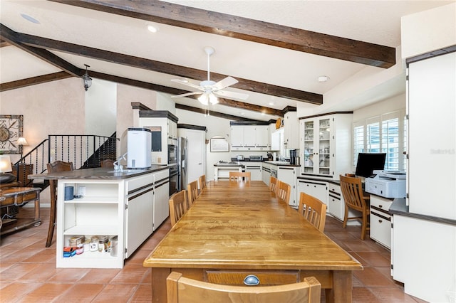 kitchen with white cabinetry, ceiling fan, and vaulted ceiling with beams