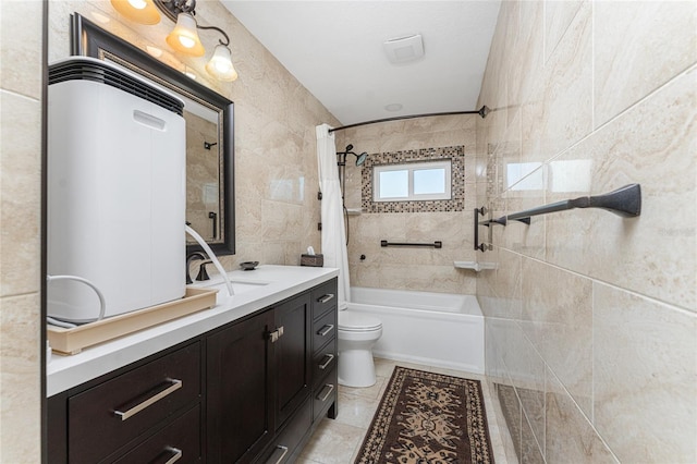 full bathroom with tile patterned flooring, shower / bathtub combination with curtain, toilet, tile walls, and vanity