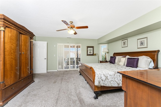 carpeted bedroom with a textured ceiling and ceiling fan