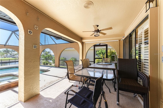 sunroom / solarium featuring ceiling fan and a healthy amount of sunlight