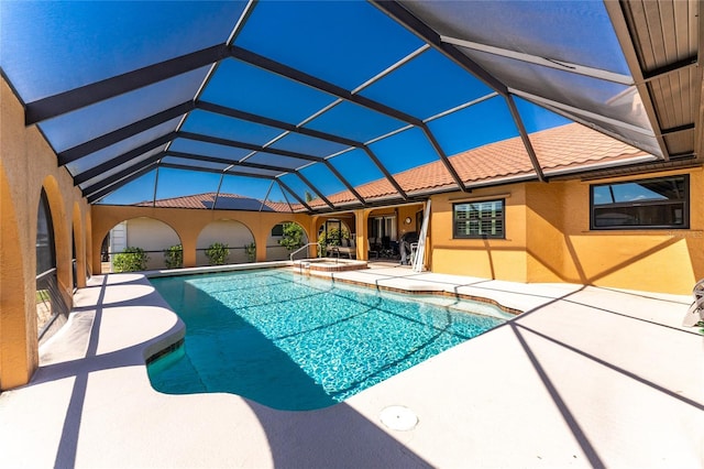 view of swimming pool with a lanai and a patio area