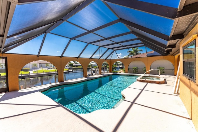 view of pool with a lanai, a water view, and a patio area