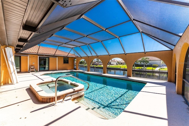 view of pool featuring a water view, a lanai, an in ground hot tub, and a patio area