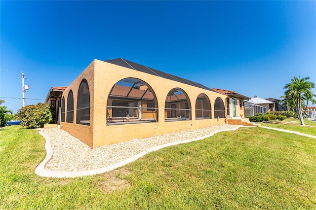 rear view of property with a lawn