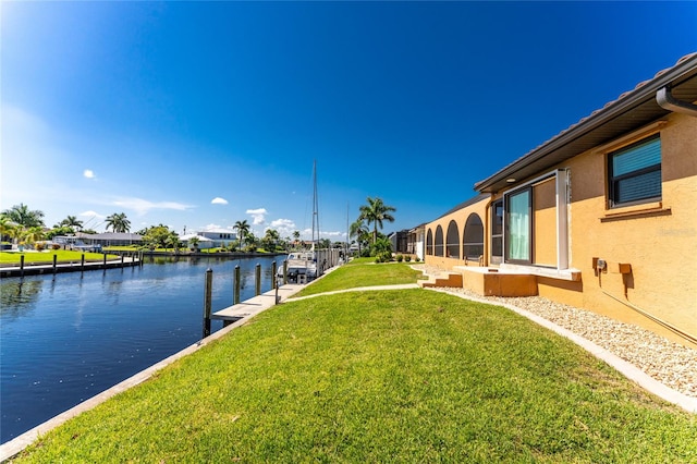 view of yard featuring a boat dock and a water view