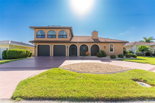 mediterranean / spanish-style house with a garage and a front yard