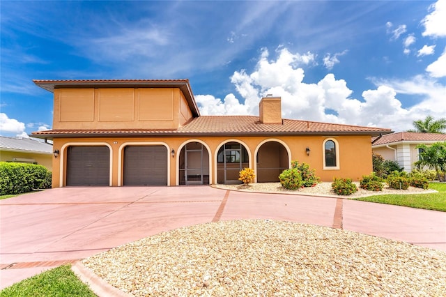 mediterranean / spanish house featuring a garage