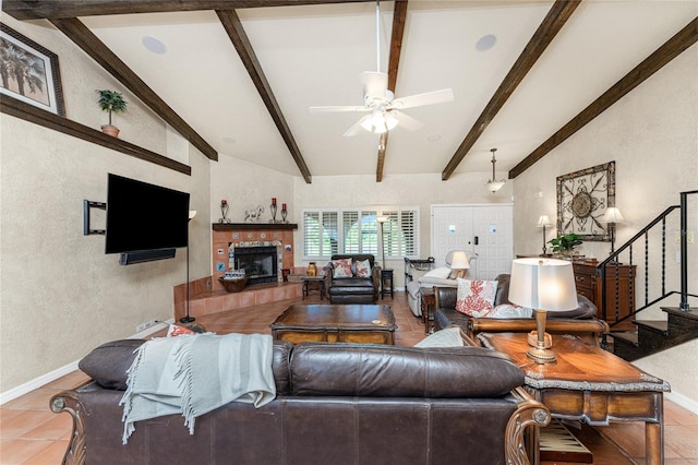 living room featuring a fireplace, tile patterned flooring, ceiling fan, and vaulted ceiling with beams