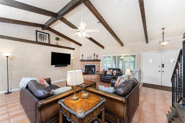 living room with ceiling fan, light tile patterned floors, vaulted ceiling with beams, and a fireplace