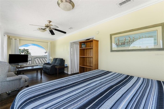 bedroom featuring a textured ceiling, crown molding, ceiling fan, and dark hardwood / wood-style floors