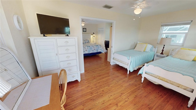 bedroom with ceiling fan and wood-type flooring