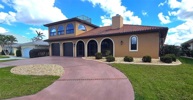 mediterranean / spanish-style house with a garage and a front lawn