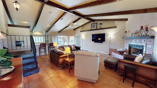 living room with lofted ceiling with beams, ceiling fan, light tile patterned flooring, and a fireplace