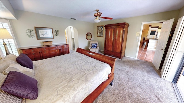 bedroom with ceiling fan and light carpet