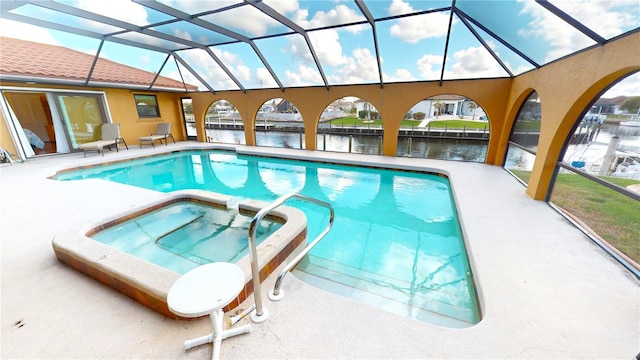 view of swimming pool featuring an in ground hot tub, a water view, glass enclosure, and a patio