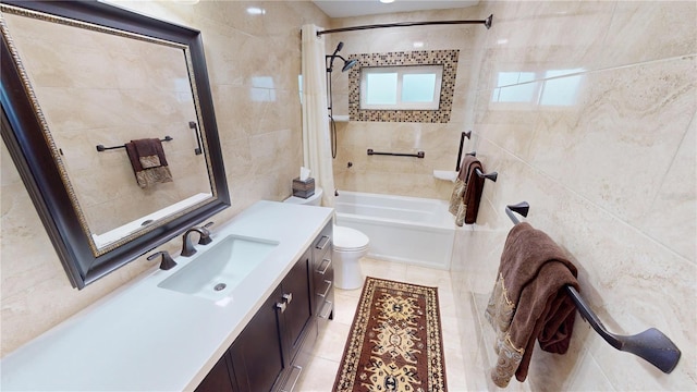 full bathroom with tile walls, tile patterned flooring, vanity, shower / bath combination with curtain, and toilet