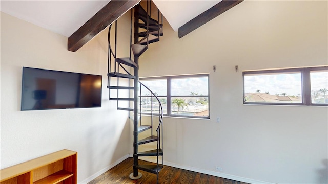 interior space with dark wood-type flooring and vaulted ceiling with beams