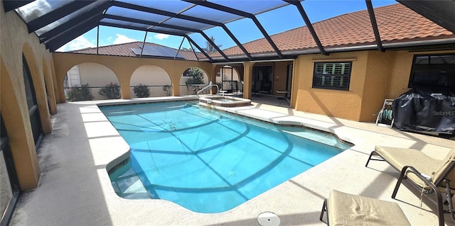 view of swimming pool with an in ground hot tub, glass enclosure, and a patio