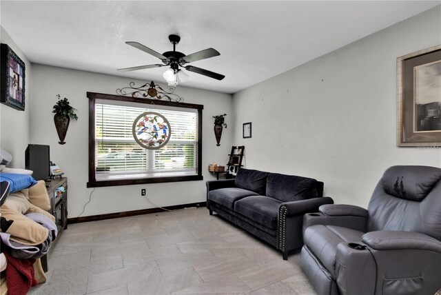 living room featuring light tile patterned flooring and ceiling fan