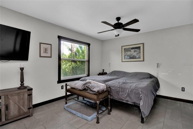 bedroom featuring light tile patterned flooring and ceiling fan