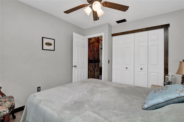 carpeted bedroom featuring a closet and ceiling fan