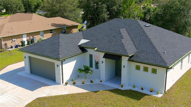 view of front of property with a garage and a front lawn