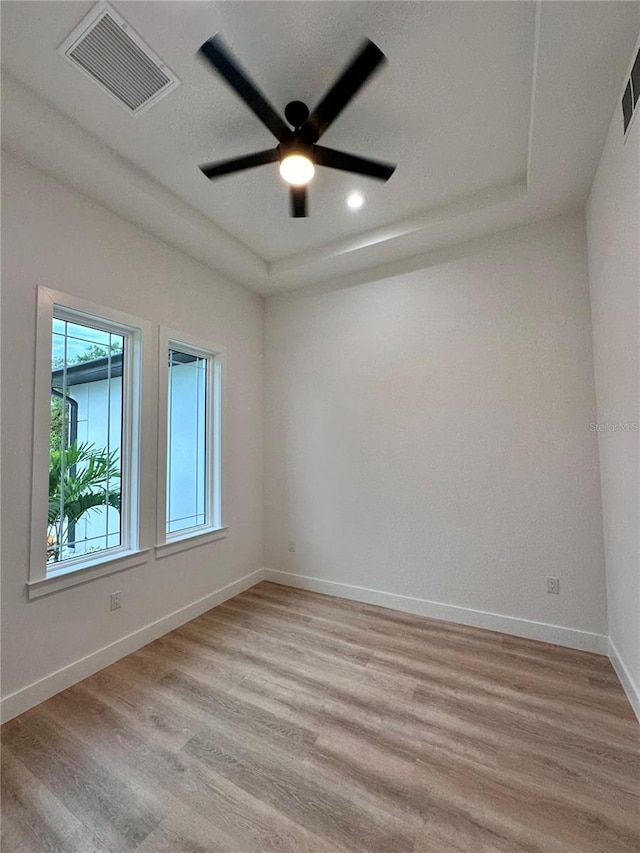 spare room featuring light hardwood / wood-style floors and ceiling fan