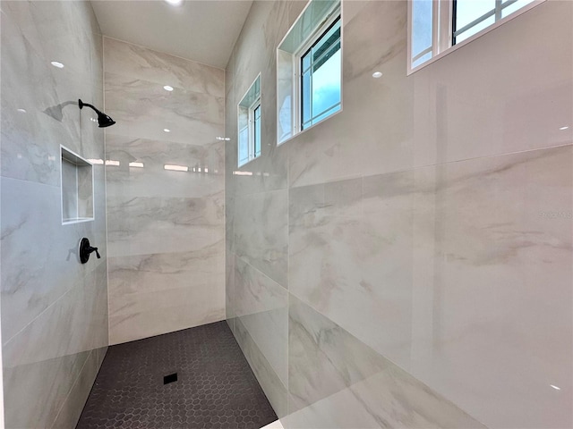 bathroom with tiled shower