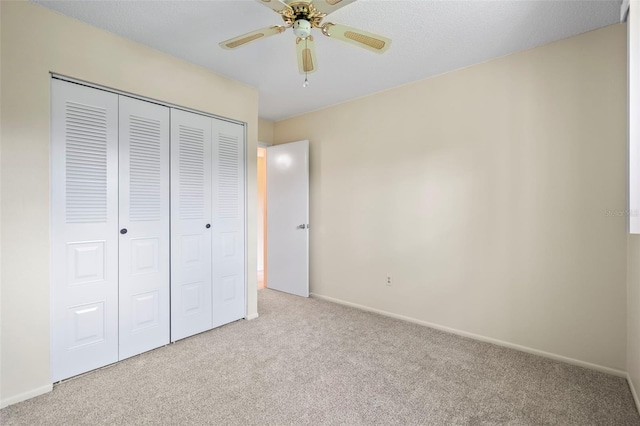 unfurnished bedroom featuring a closet, ceiling fan, and light carpet