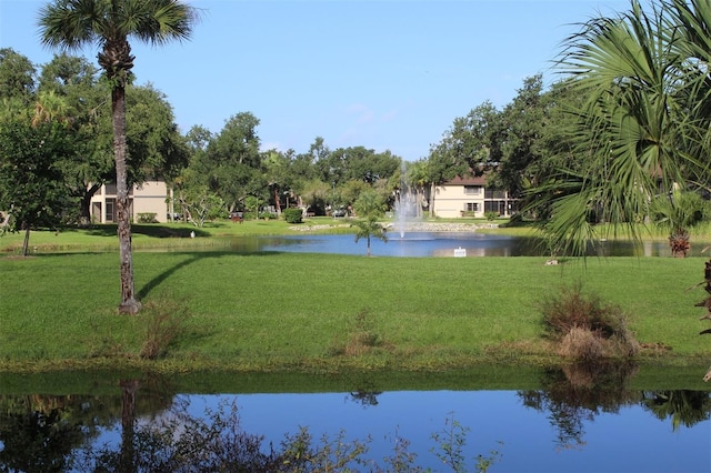 view of home's community with a lawn and a water view