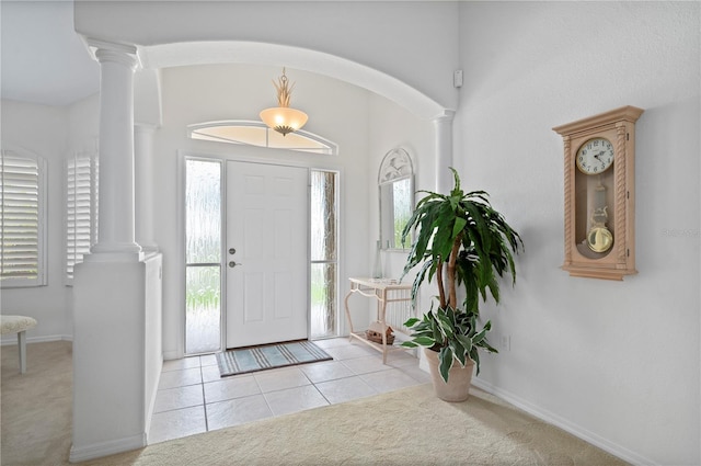 foyer featuring light colored carpet and decorative columns