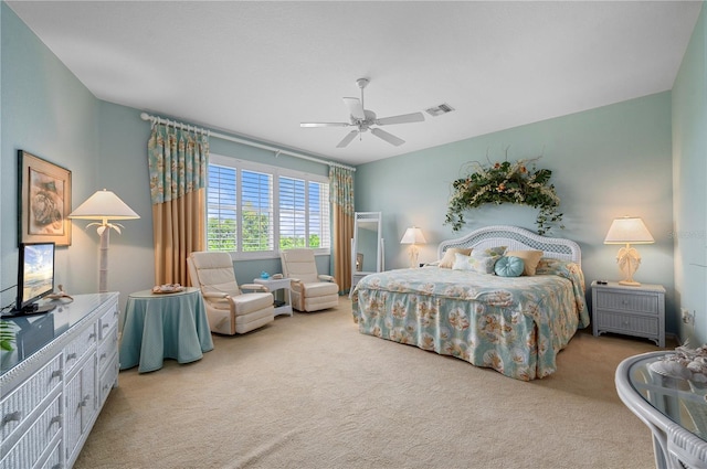 bedroom with ceiling fan, visible vents, and light colored carpet