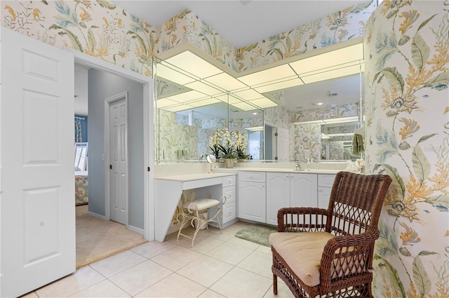 full bathroom with wallpapered walls, tile patterned flooring, baseboards, and vanity