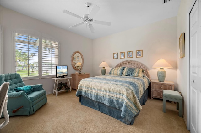 carpeted bedroom with a closet and ceiling fan