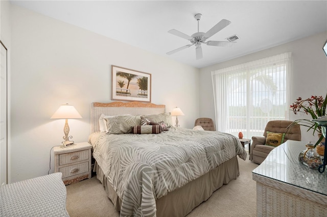 bedroom with light carpet, a ceiling fan, visible vents, and access to exterior