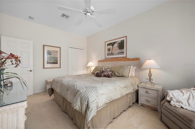 carpeted bedroom with ceiling fan and a closet