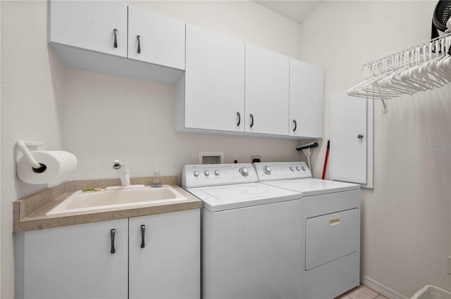 laundry area with cabinets, sink, and washing machine and clothes dryer