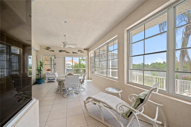 sunroom featuring ceiling fan