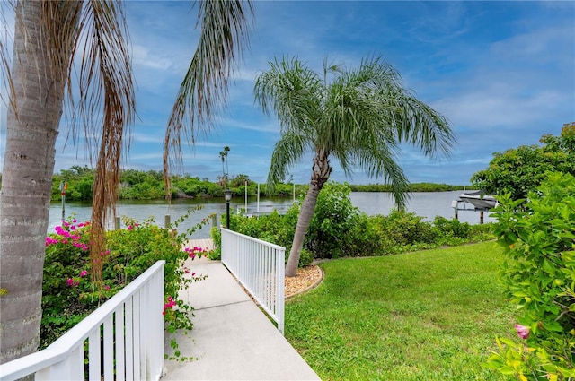 exterior space with a lawn and a water view