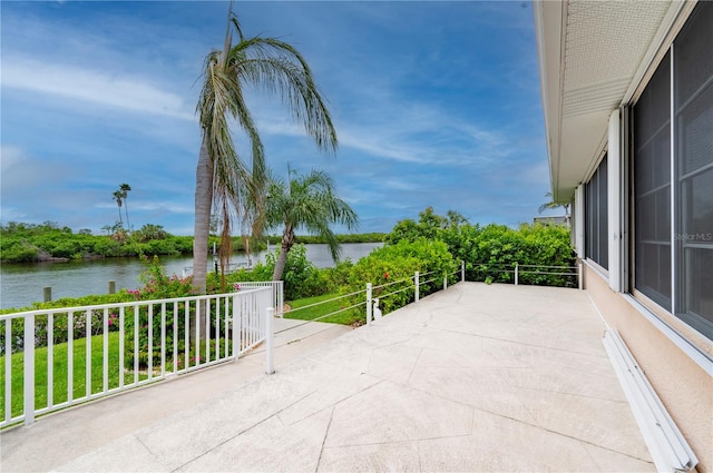 view of patio / terrace featuring a balcony and a water view