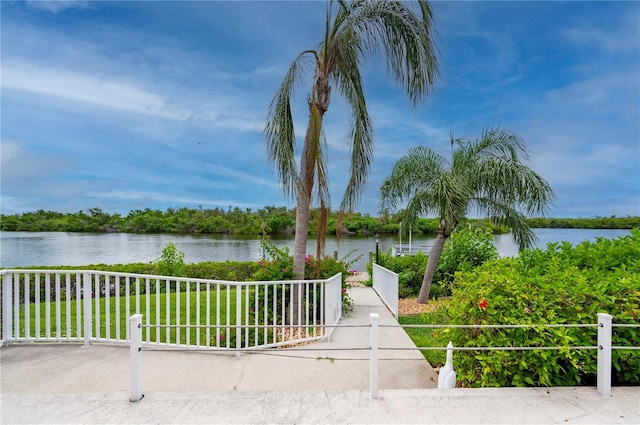 view of home's community featuring a yard and a water view