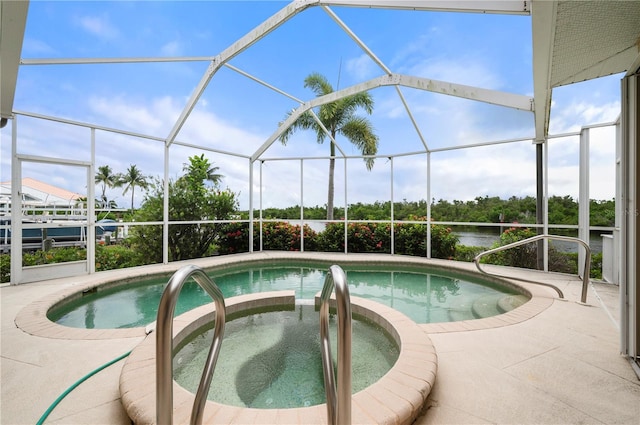 view of pool featuring a water view, glass enclosure, an in ground hot tub, and a patio area