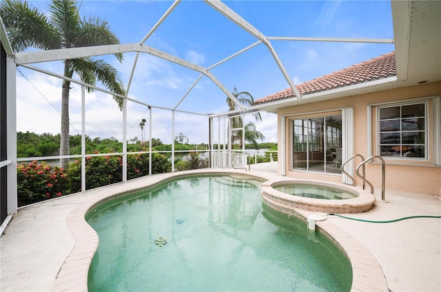 view of swimming pool featuring glass enclosure, a patio, and a pool with connected hot tub