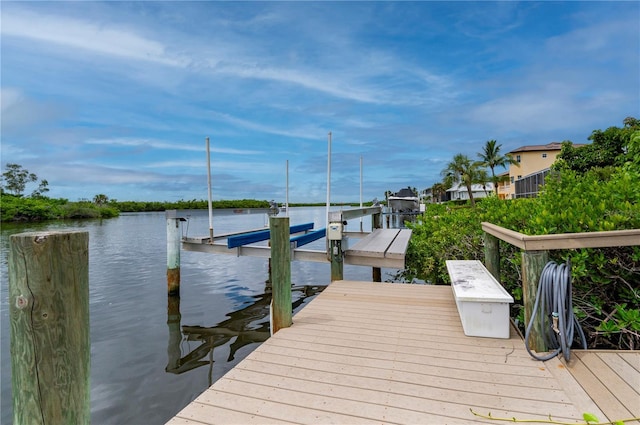 dock area with a water view and boat lift