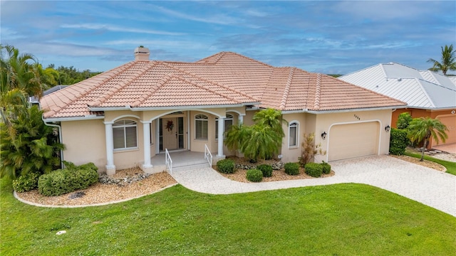 mediterranean / spanish-style home featuring a front yard and a garage