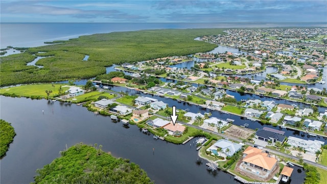 birds eye view of property with a water view and a residential view