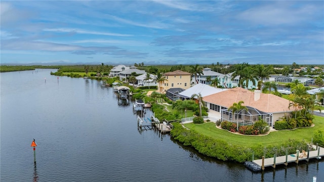 birds eye view of property with a water view and a residential view