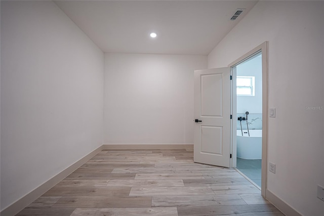 empty room with light hardwood / wood-style flooring